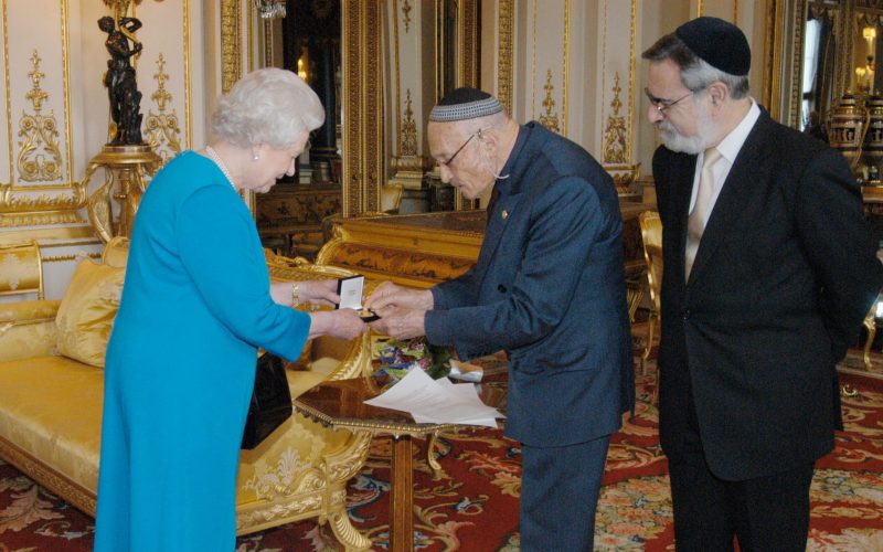 Queen Elizabeth II is presented with the Interfaith Gold Medallion Peace through Dialogue from Sir Sigmund Sternberg, joined by Chief Rabbi, Sir Jonathan Sacks (right).